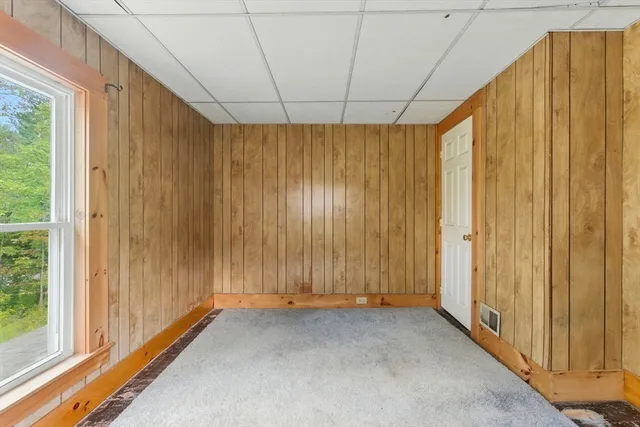 a view of a room with wooden floor and windows