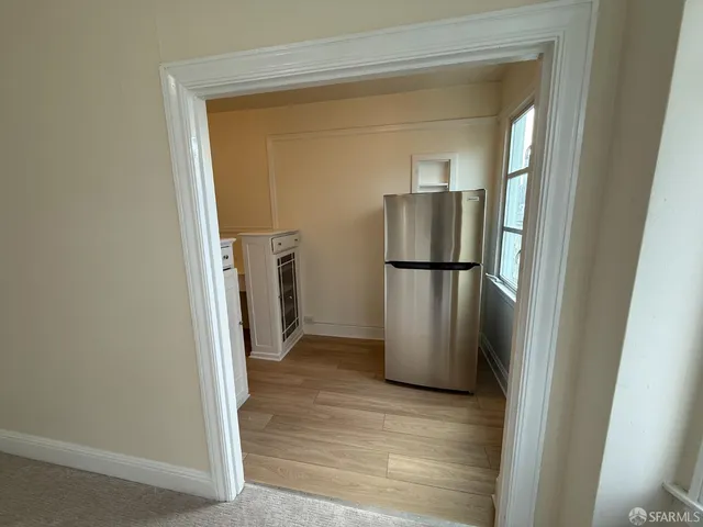 a view of a kitchen from a hallway