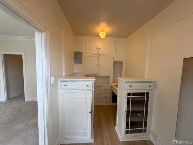 a view of a kitchen with cabinets and stainless steel appliances