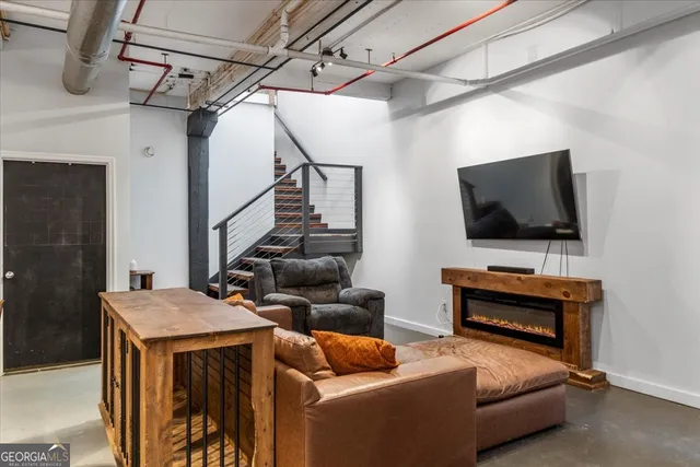 a living room with furniture and a flat screen tv
