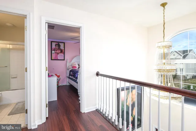 a view of a hallway view with wooden floor and staircase