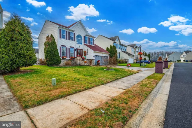a view of a white house with a yard