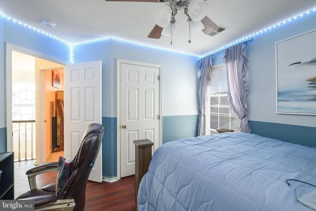 a bedroom with a bed dresser and a window