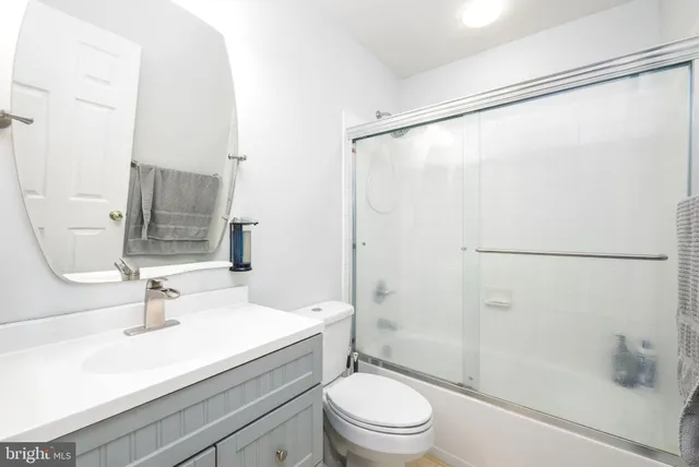 a bathroom with a sink mirror toilet and shower