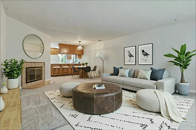 a living room with furniture a fireplace and a potted plant