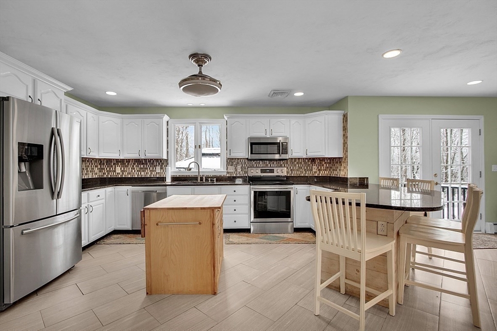 6 Fitch Farm Road Sterling, MA 01564 - Photo 4 of 41 a kitchen with white cabinets and stainless steel appliances