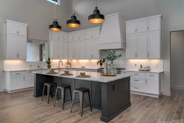 a kitchen with a sink cabinets and wooden floor