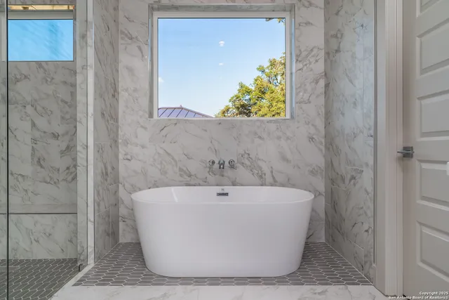 a white bath tub sitting in a bathroom