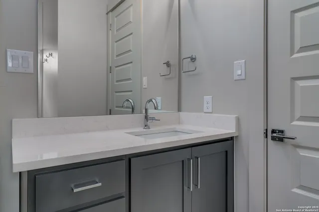 a bathroom with a sink and a mirror