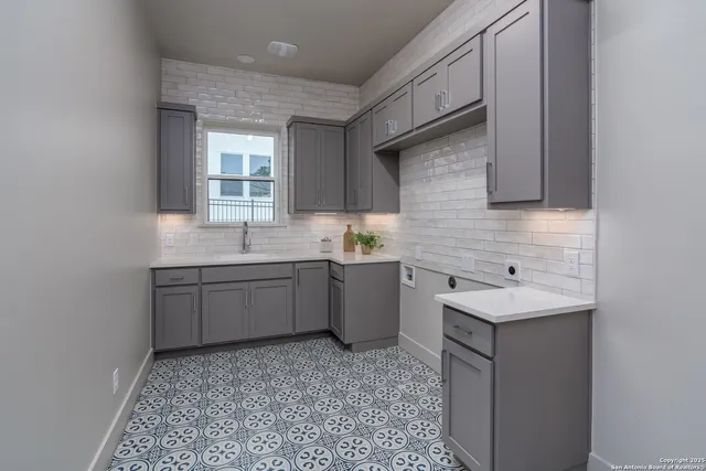 a kitchen with a sink cabinets and window