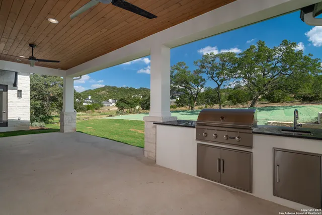 a open kitchen with a stove and a large window