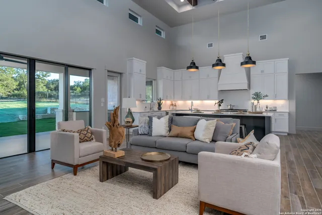 a living room with furniture and floor to ceiling windows