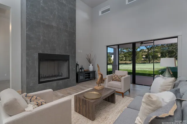 a living room with furniture and a fireplace