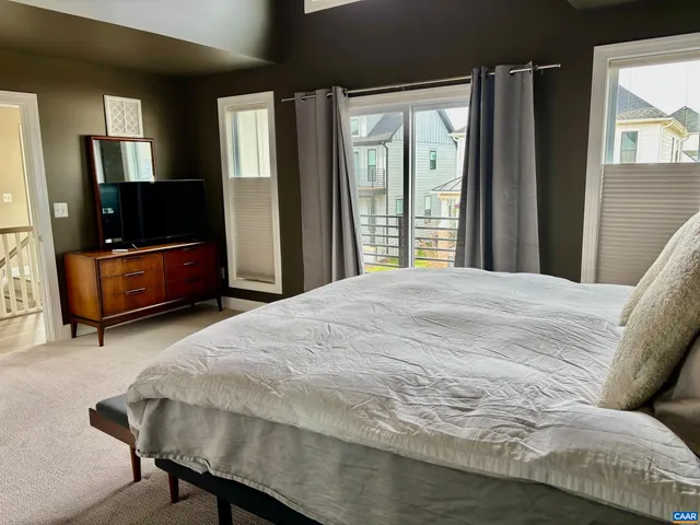 a bedroom with a bed and glass door