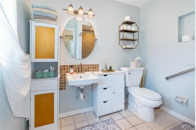 a bathroom with a toilet sink and mirror
