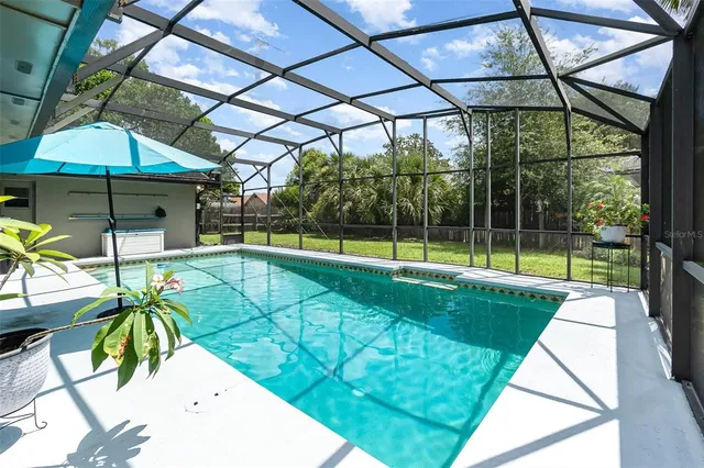 a view of a backyard with swimming pool