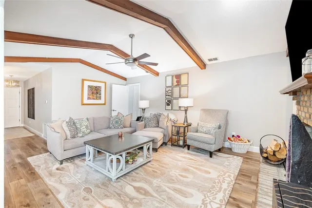 a living room with furniture a rug and a flat screen tv