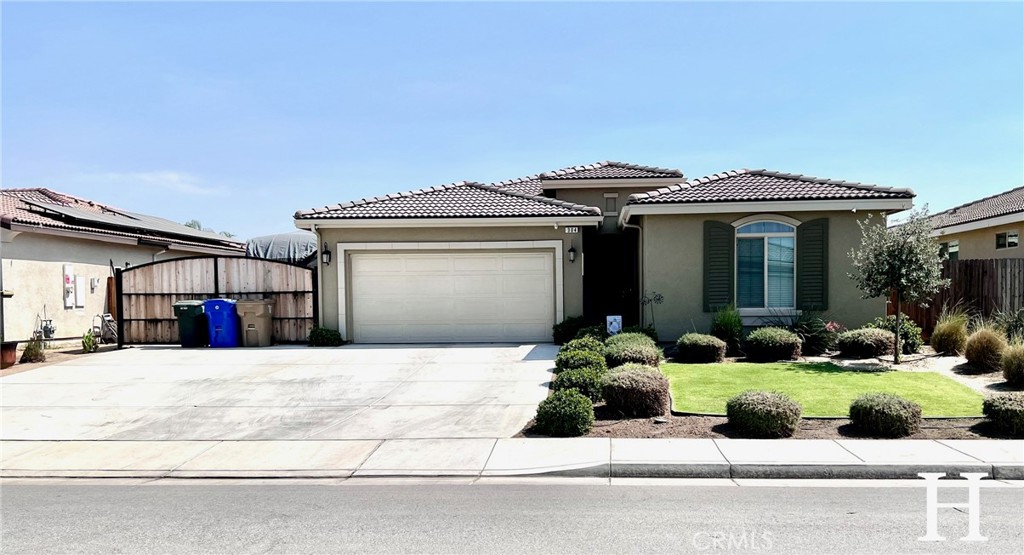 304 Hammersmith Drive Bakersfield, CA 93314 - Photo 1 of 1 a front view of a house with a yard and garage
