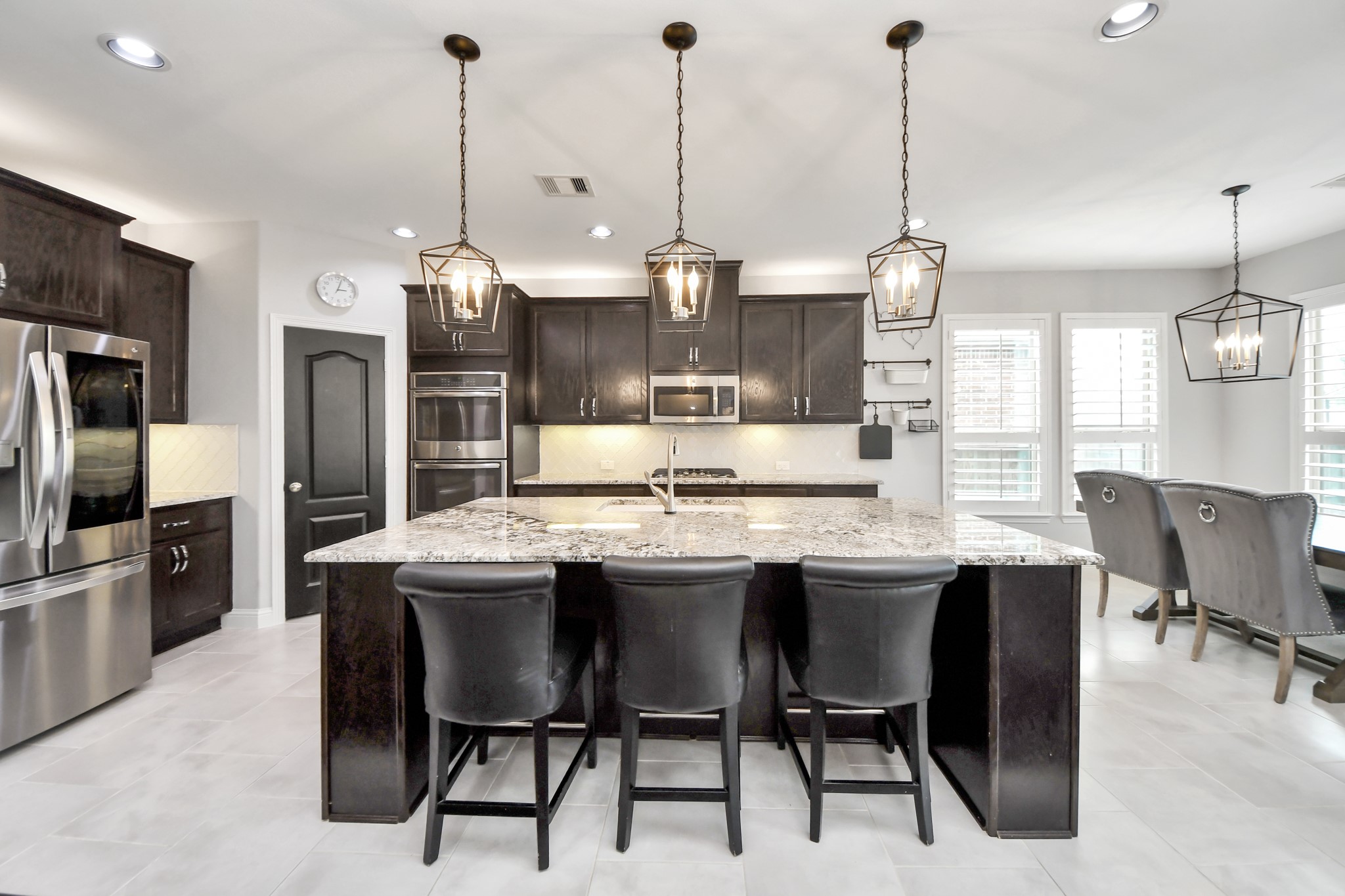 2811 Hadley Springs Lane Spring, TX 77386 - Photo 8 of 50 a kitchen with stainless steel appliances kitchen island granite countertop a table chairs and a refrigerator