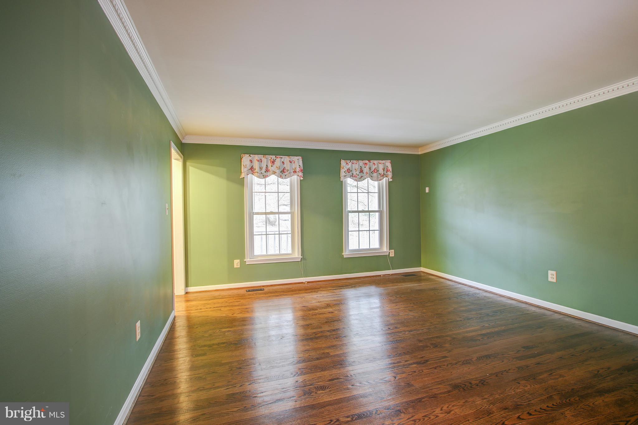 700 Bryants Nursery Road Silver Spring, MD 20905 - Photo 5 of 41 a view of an empty room with wooden floor and a window