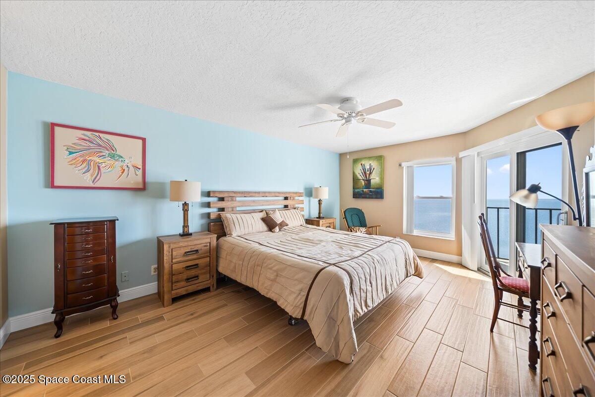 3220 River Villa Way, Unit 151 Melbourne Beach, FL 32951 - Photo 11 of 51 a bedroom with bed and wooden floor