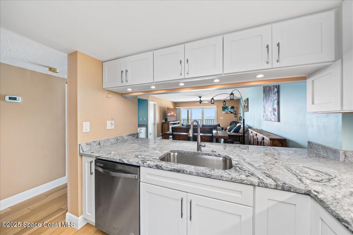 3220 River Villa Way, Unit 151 Melbourne Beach, FL 32951 - Photo 19 of 51 a kitchen with stainless steel appliances granite countertop a sink and cabinets