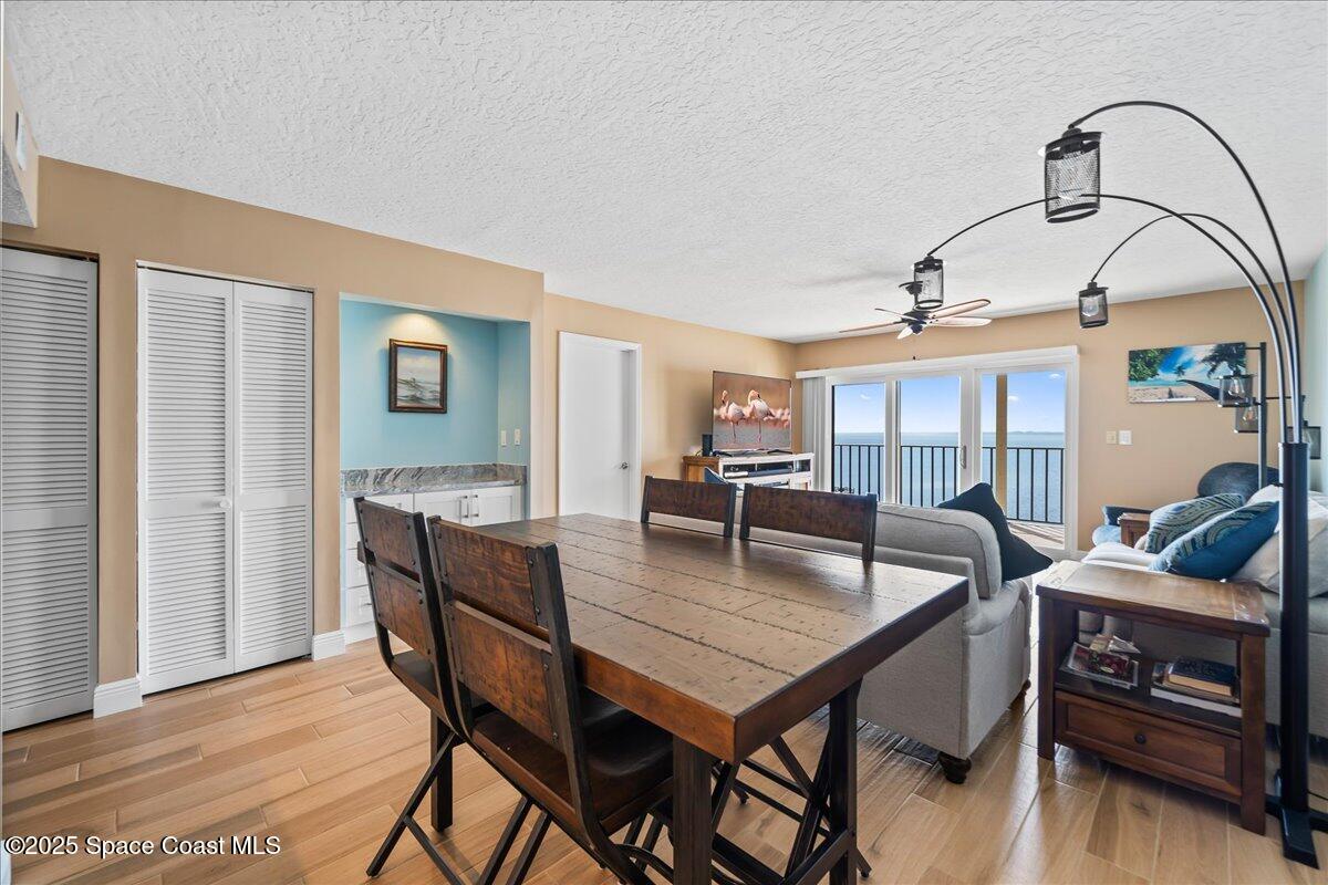 3220 River Villa Way, Unit 151 Melbourne Beach, FL 32951 - Photo 28 of 51 a view of a dining room with furniture and wooden floor