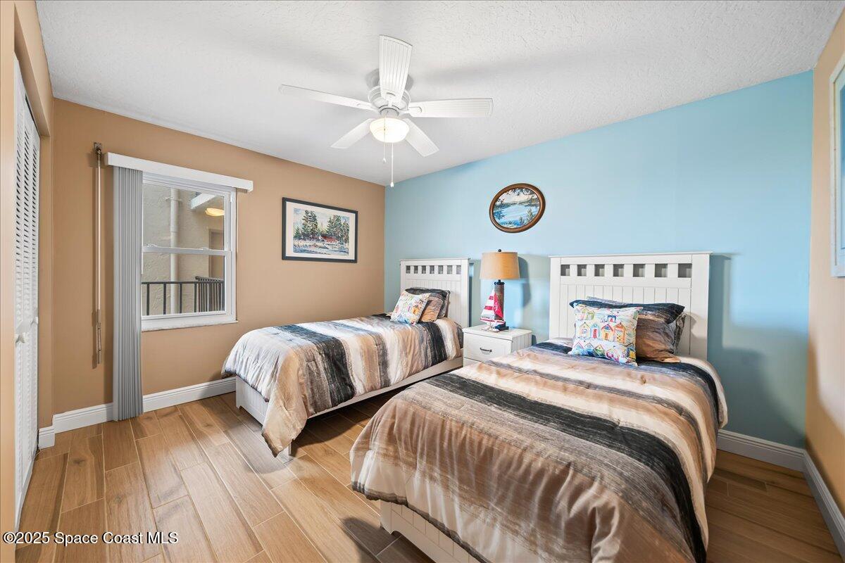 3220 River Villa Way, Unit 151 Melbourne Beach, FL 32951 - Photo 32 of 51 a bedroom with two beds and a table