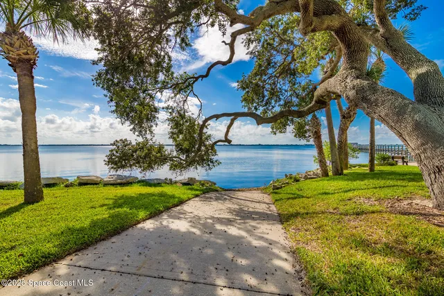 an aerial view of a house with swimming pool and a yard