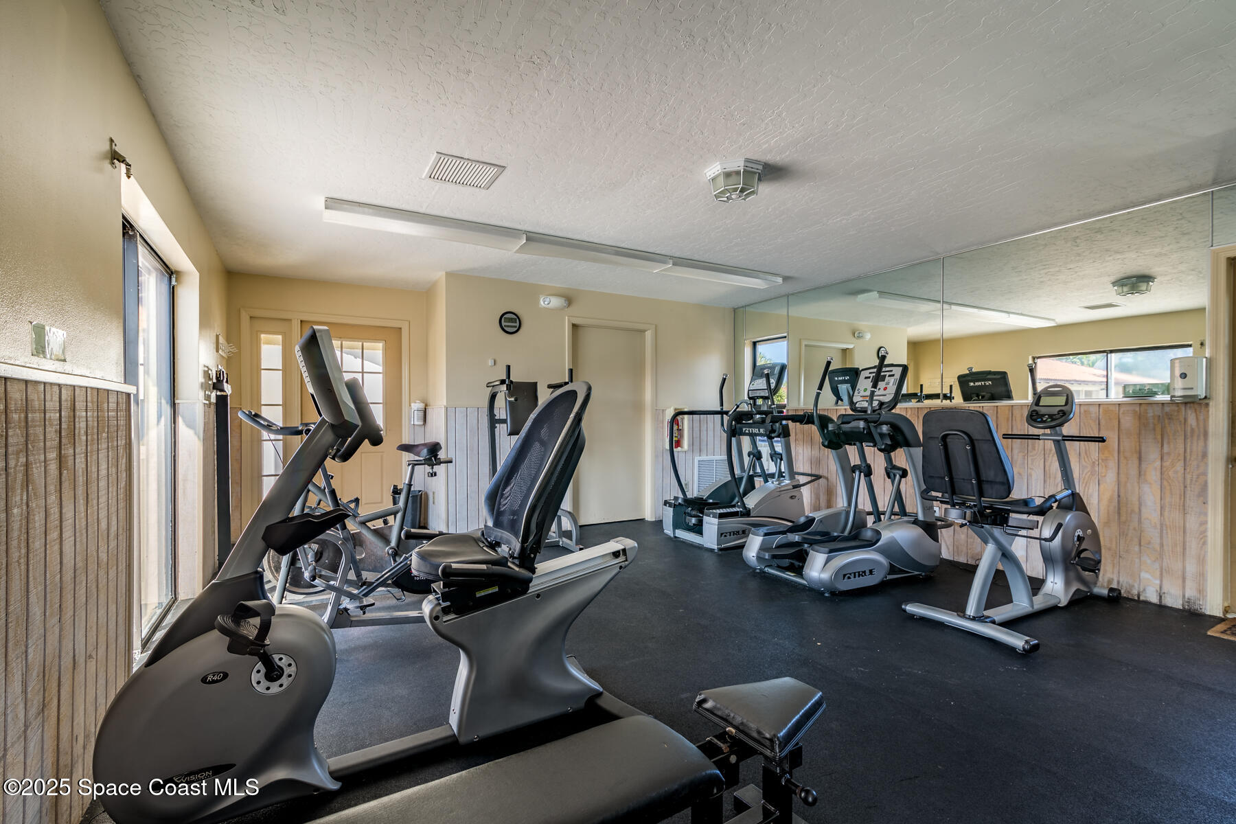 3220 River Villa Way, Unit 151 Melbourne Beach, FL 32951 - Photo 46 of 51 a room with gym equipment and windows