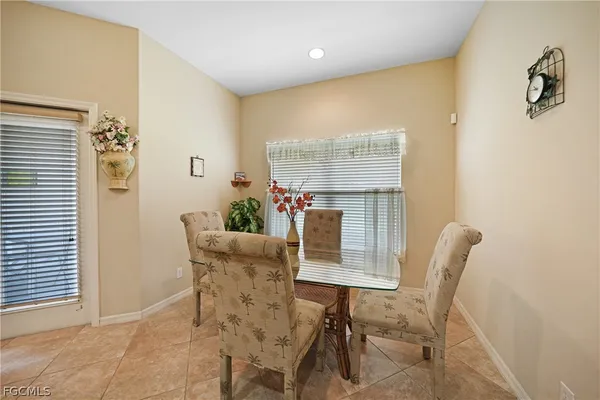 a dining room with furniture and window