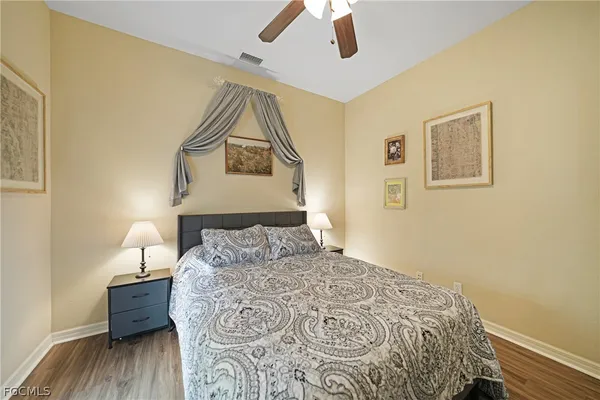 a bedroom with a bed and a wooden floor