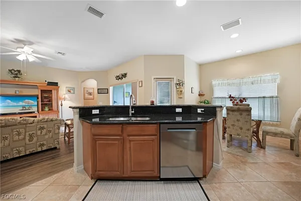 a kitchen with stainless steel appliances granite countertop a sink and a stove