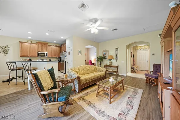 a living room with furniture and kitchen view