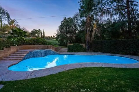 a view of a swimming pool with a yard