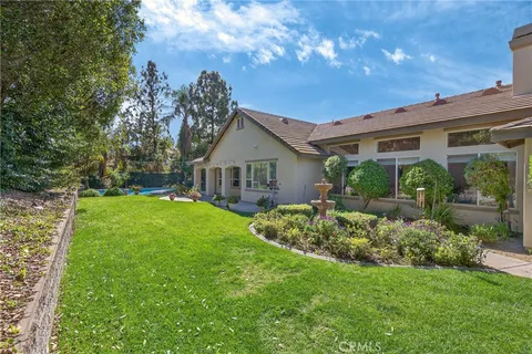 a front view of house with a garden