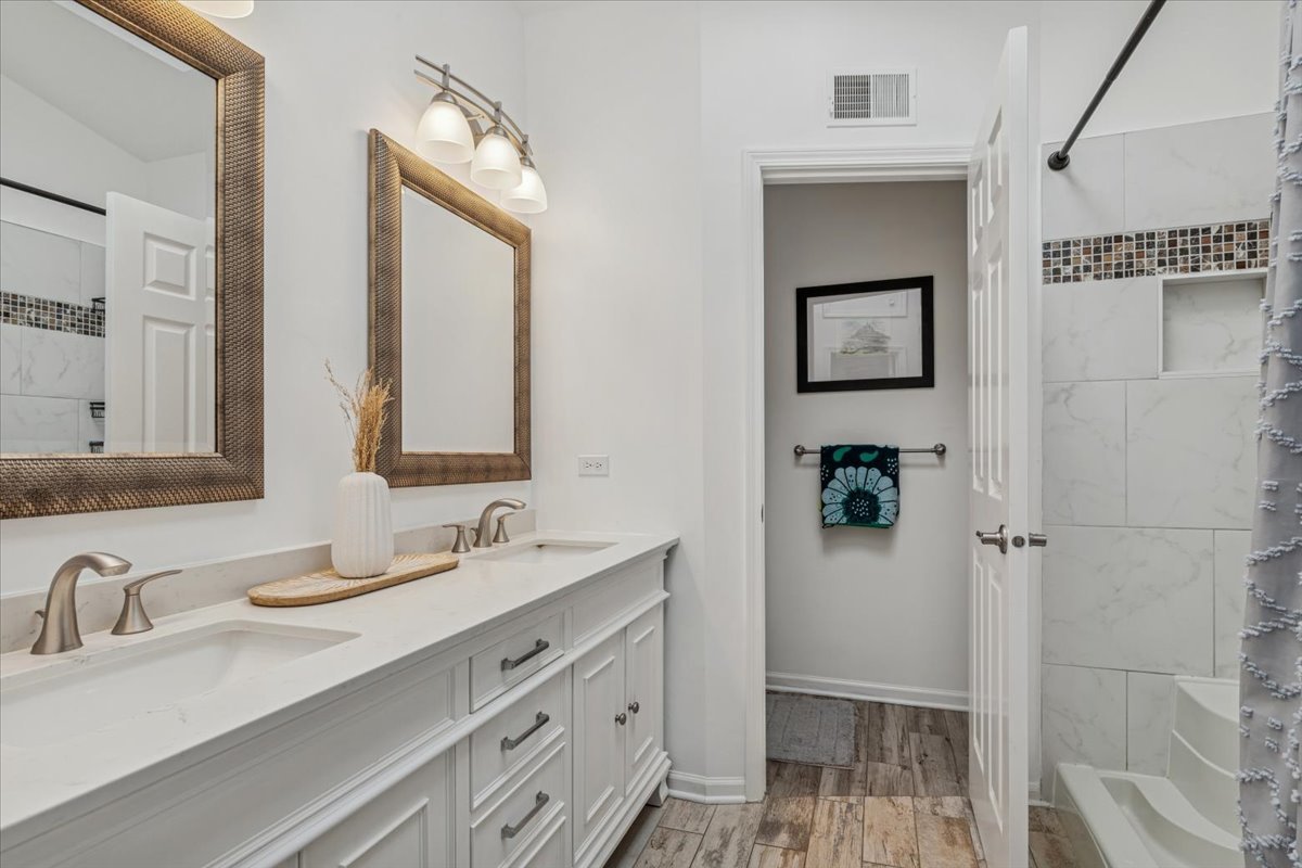 1321 Longacre Lane Wheeling, IL 60090 - Photo 12 of 23 a bathroom with double vanity sink a mirror and a shower
