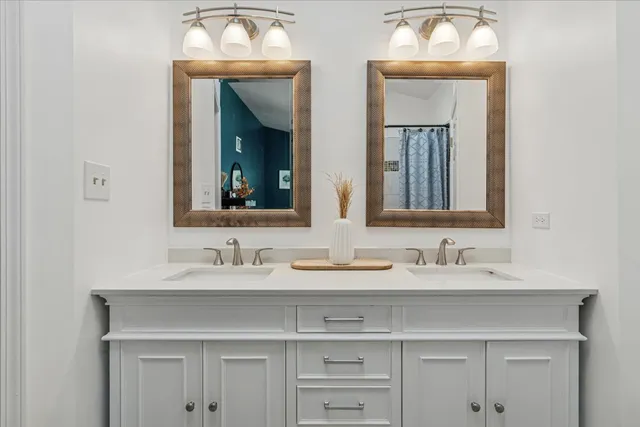 a bathroom with a sink vanity and a mirror