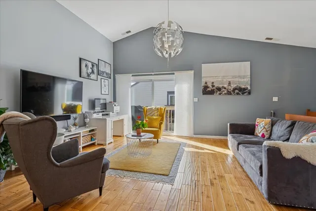 a living room with furniture and a chandelier