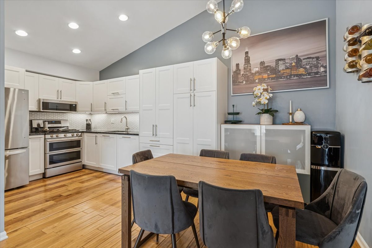 1321 Longacre Lane Wheeling, IL 60090 - Photo 6 of 23 a kitchen with stainless steel appliances kitchen island granite countertop a dining table and chairs