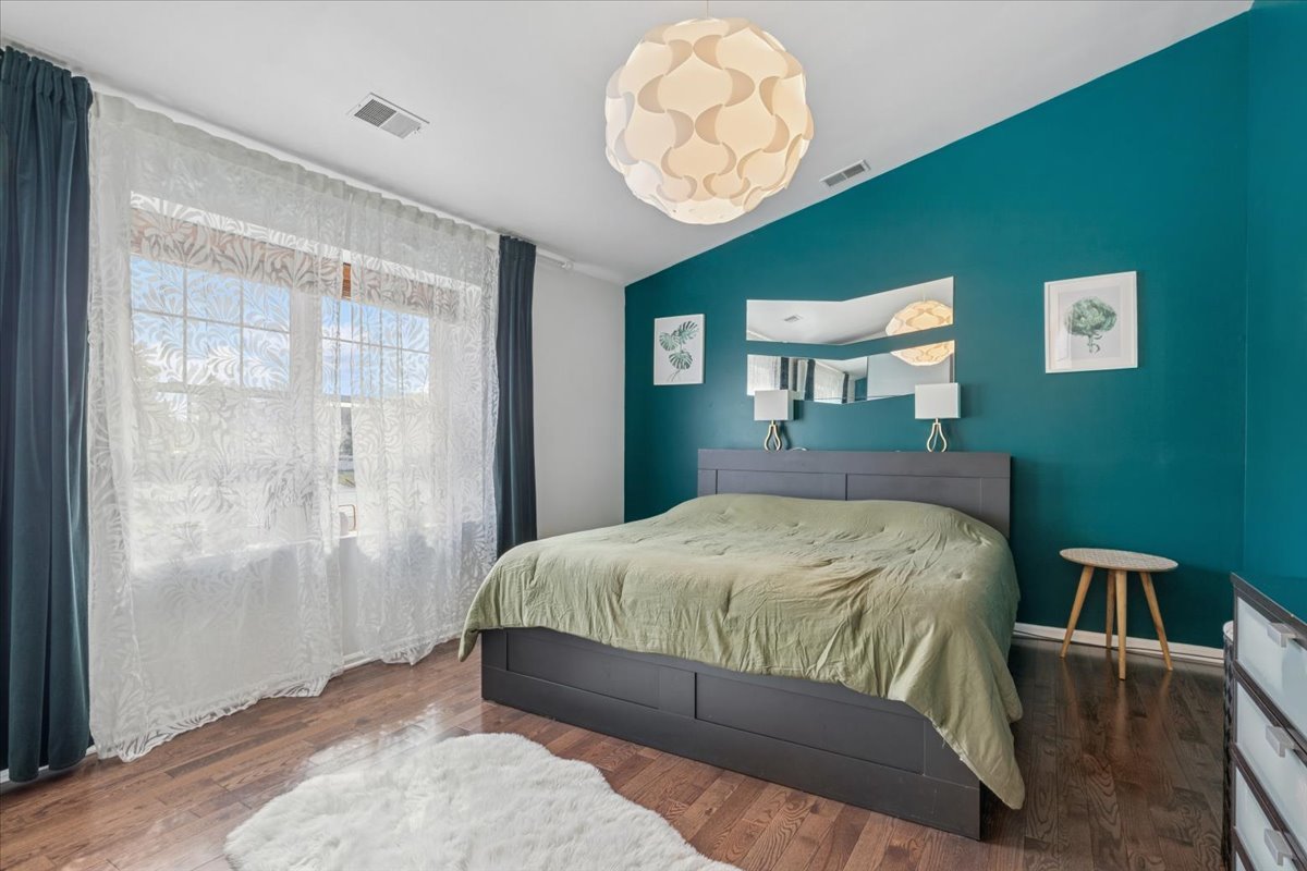 1321 Longacre Lane Wheeling, IL 60090 - Photo 10 of 23 a bedroom with a bed mirror and a window