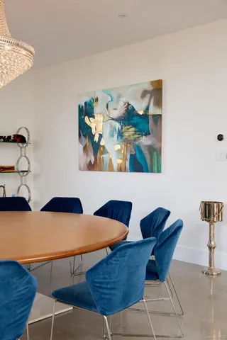 a living room with furniture and painting on the wall