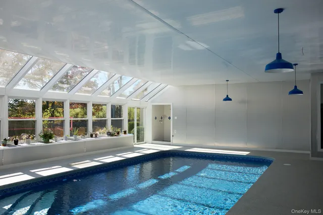 a living room with a large window and furniture