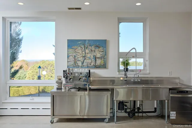 a kitchen with stainless steel appliances granite countertop a sink and a window