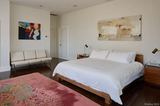 a bedroom with bed and wall painting