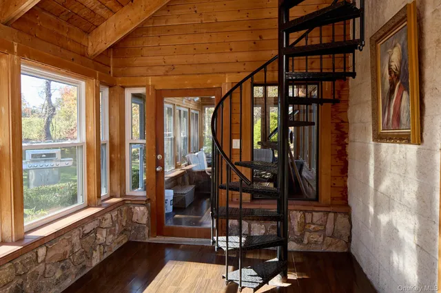 a view of an entryway with wooden floor