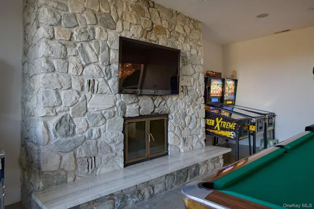 a living room with fireplace and a wooden floor