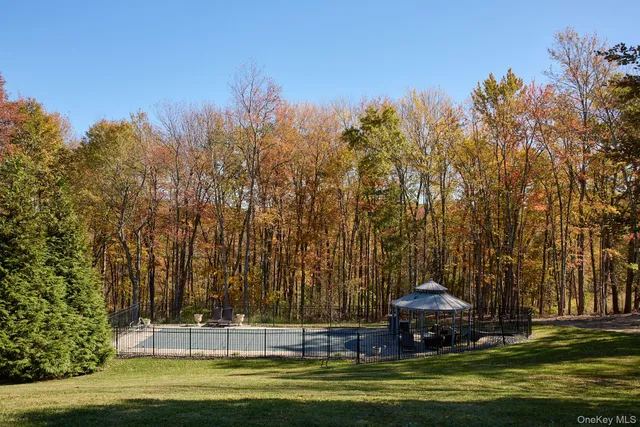 a swimming pool with trees in the background