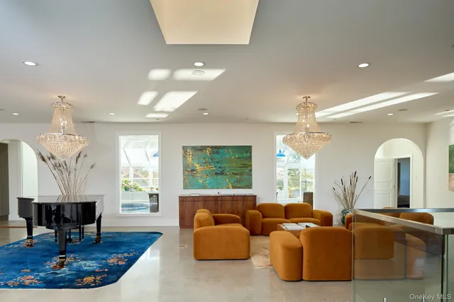 a living room with fireplace furniture and a large window