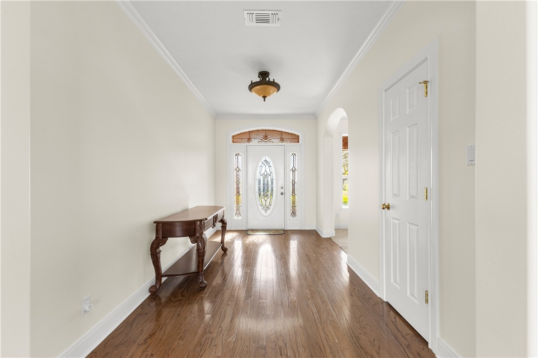 2120 Hohenwalde School Road Brenham, TX 77833 - Photo 7 of 30 a hallway with wooden floor chandelier and entryway
